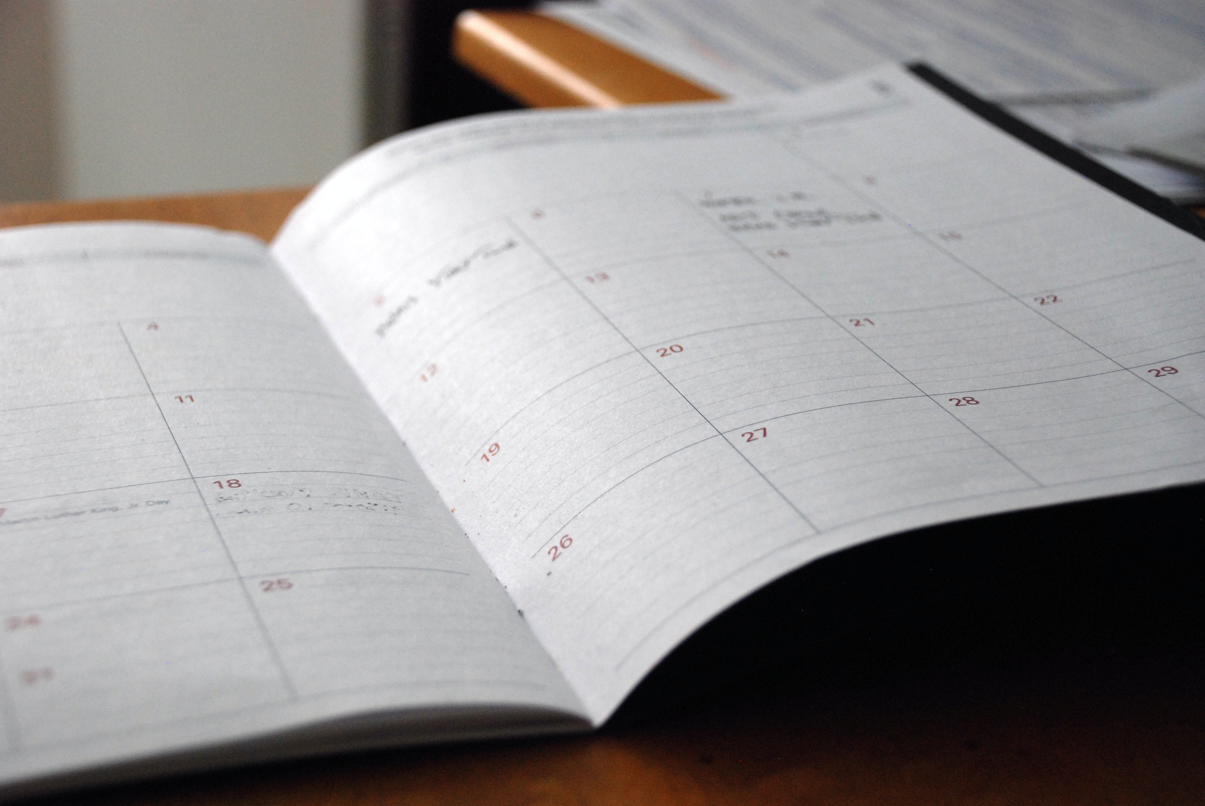 A desk calendar open on top of a desk.