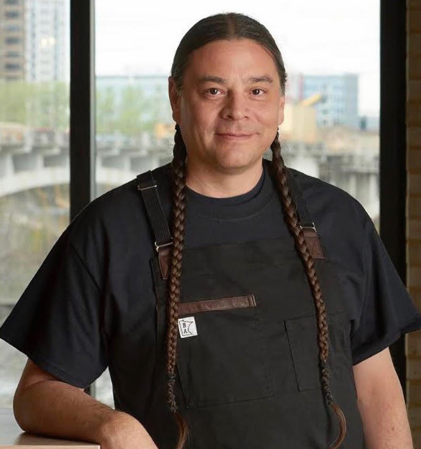 Chef Sean Sherman standing in his restaurant, Owamni.